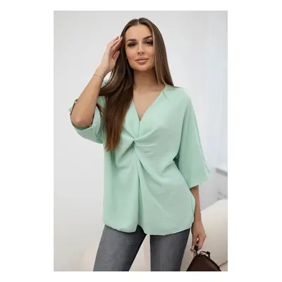 Oversized blouse with a light mint neckline