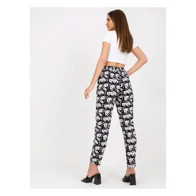 Black light trousers in fabric with flowers SUBLEBEL