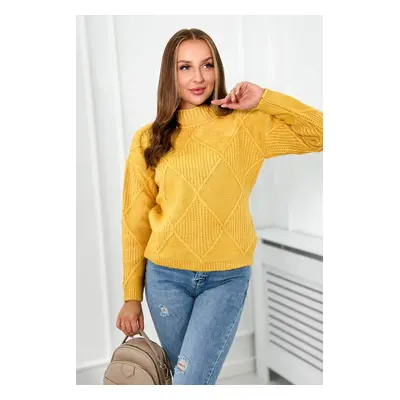 Diamond mustard sweater draped over the head