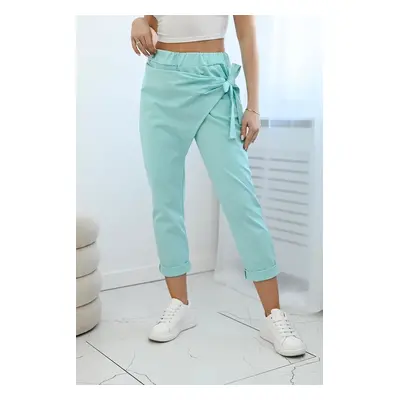 Trousers with asymmetrical mint tie at the front