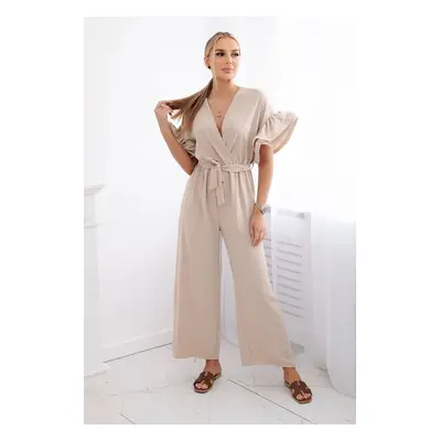 Jumpsuit with a tie at the waist with decorative sleeves in beige color