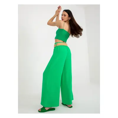 Green wide trousers made of fabric with a belt