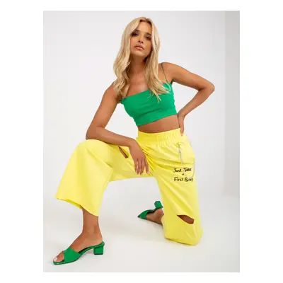 Yellow wide sweatpants with inscriptions