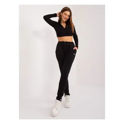 Black sweatpants with decorative cuffs