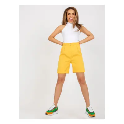 Elegant dark yellow long shorts with a high waist