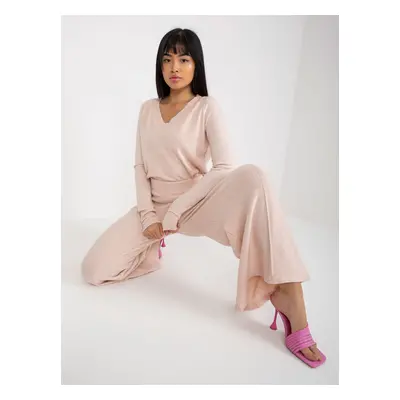 Light pink knitted trousers with a wide leg