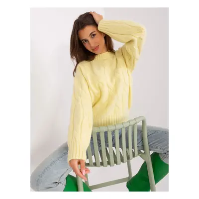 Light yellow sweater with cables and cuffs