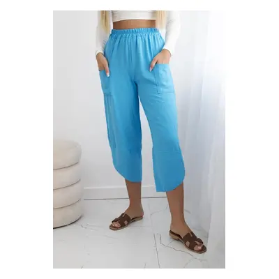 Turquoise trousers with wide legs and pockets