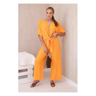 Set of bright orange blouse and trousers