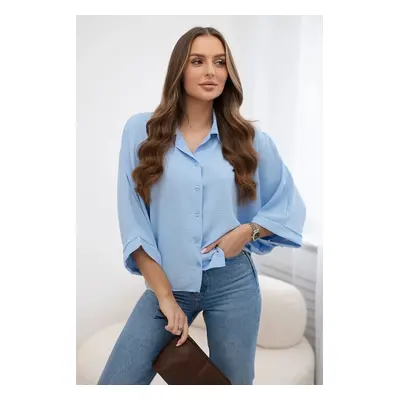 Oversized blouse with blue button fastening