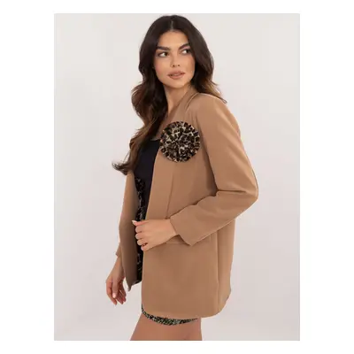 Brown blazer with a floral brooch