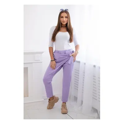 Trousers tied with an asymmetrical light purple front